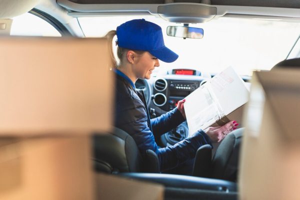 woman-with-packed-box-car_23-2147767783